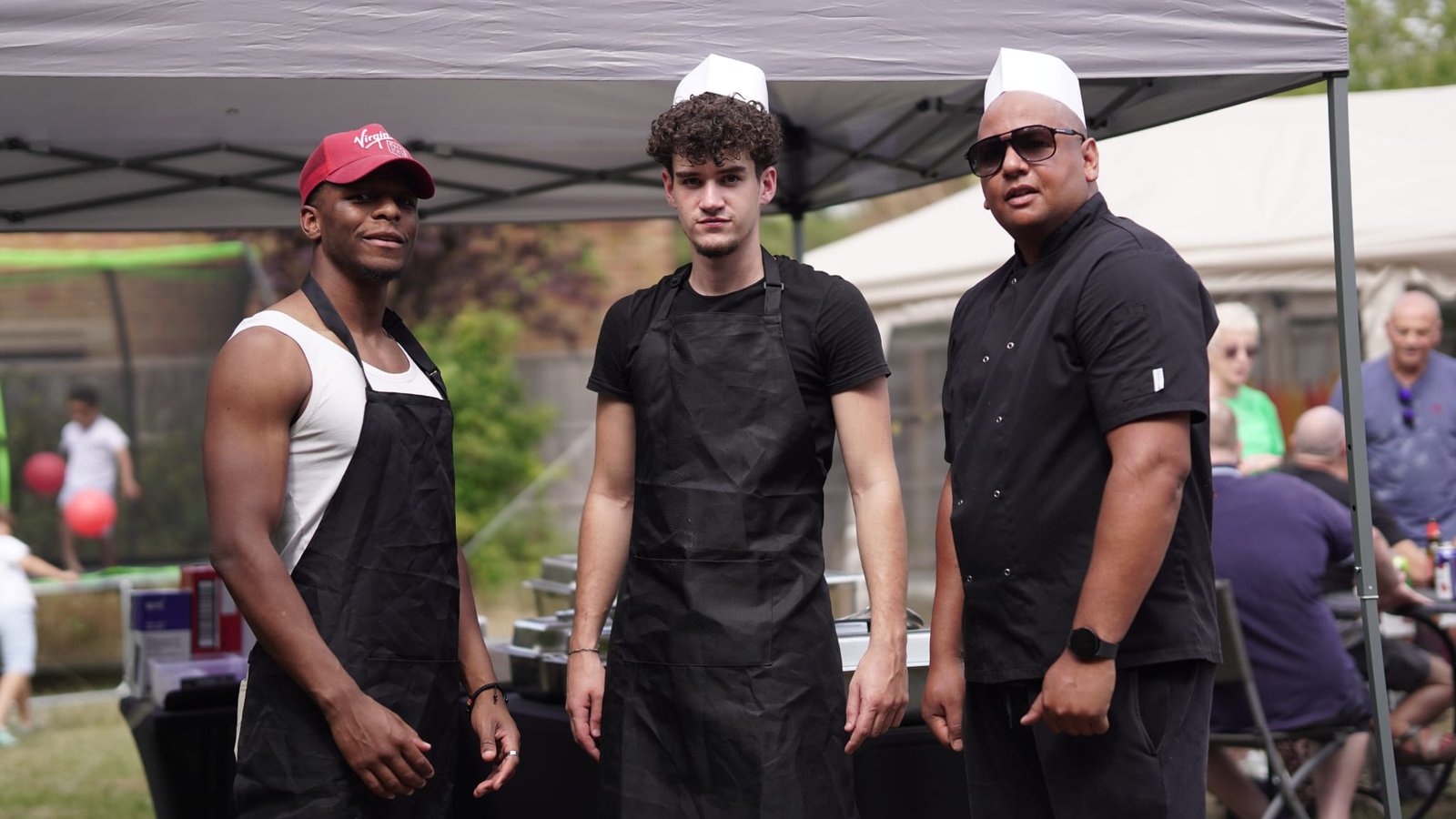 Three members of the Grill Seekers cooking team at an event